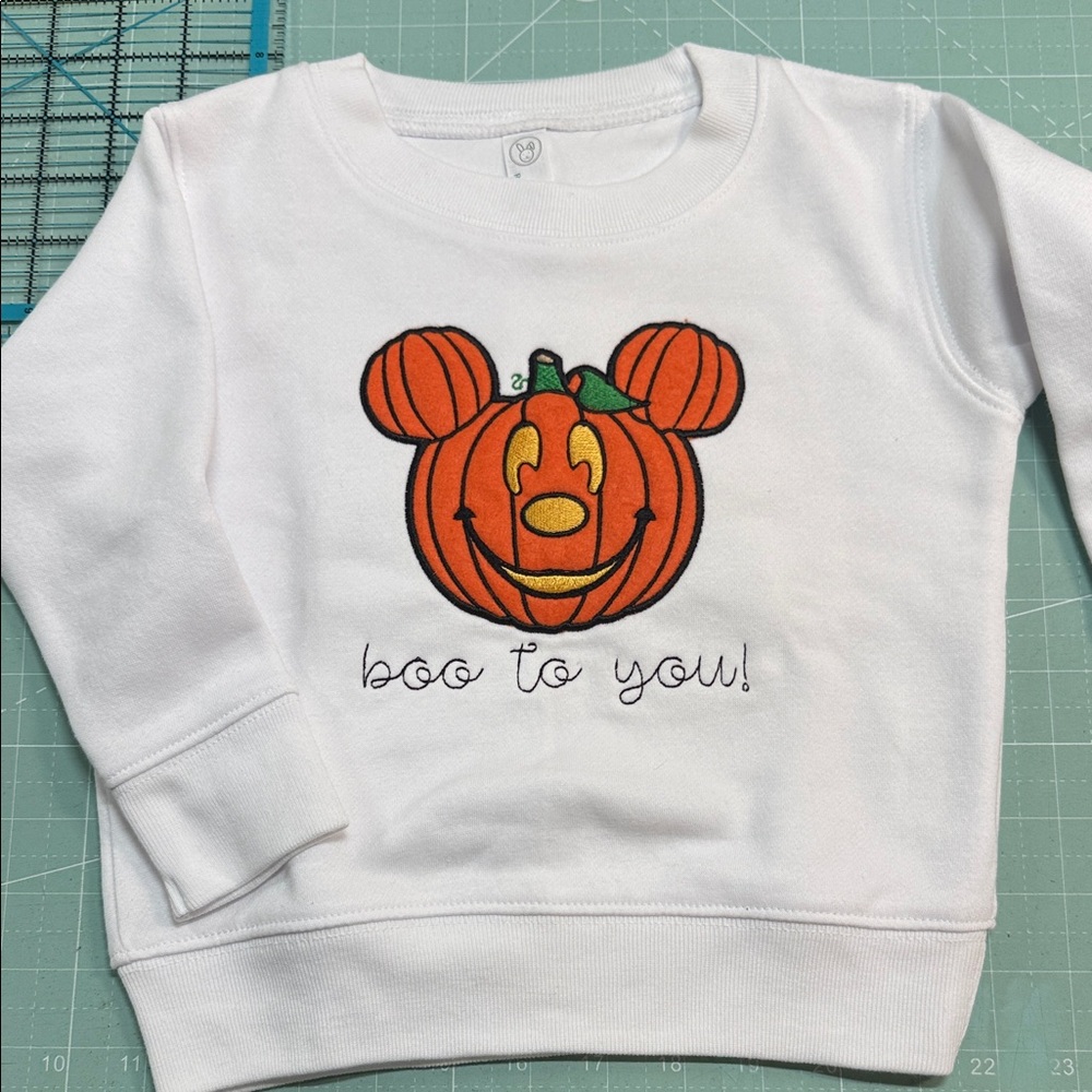 Rabbit Skins White Sweatshirt with Orange Pumpkin Mickey Graphic